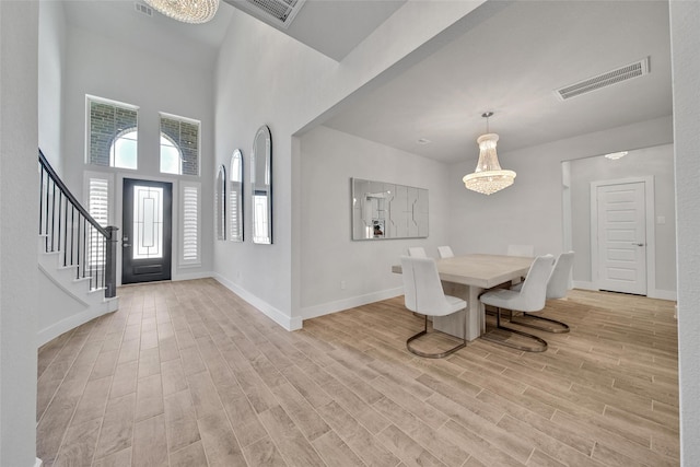 entrance foyer featuring light wood finished floors, stairway, and visible vents