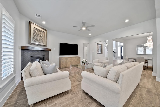 living area with recessed lighting, visible vents, baseboards, and wood finish floors