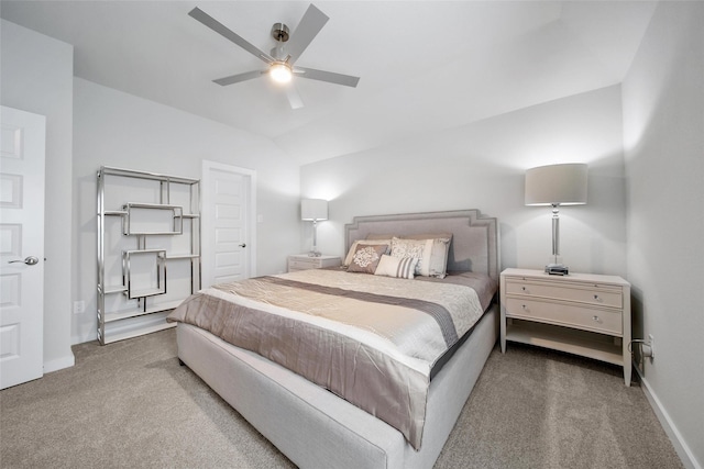 carpeted bedroom featuring vaulted ceiling, a ceiling fan, and baseboards