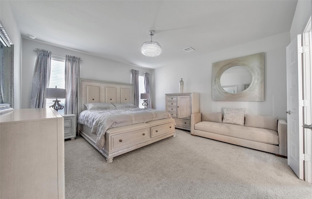 bedroom with light colored carpet and visible vents