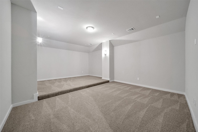 interior space with carpet floors, visible vents, and baseboards