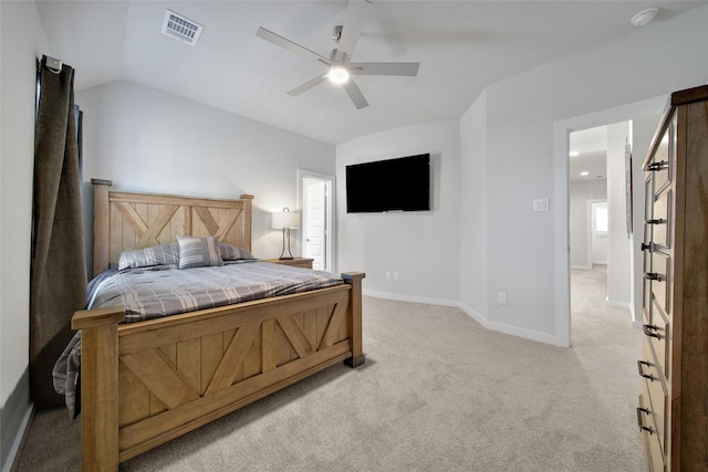 bedroom with light colored carpet, visible vents, a ceiling fan, vaulted ceiling, and baseboards