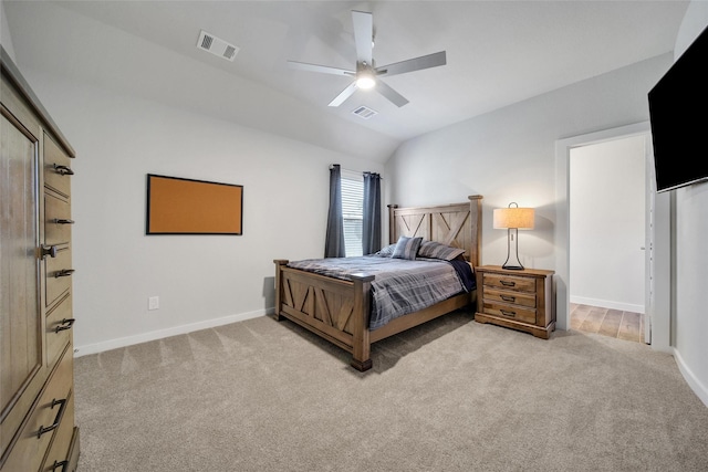 bedroom featuring light colored carpet, visible vents, lofted ceiling, and baseboards