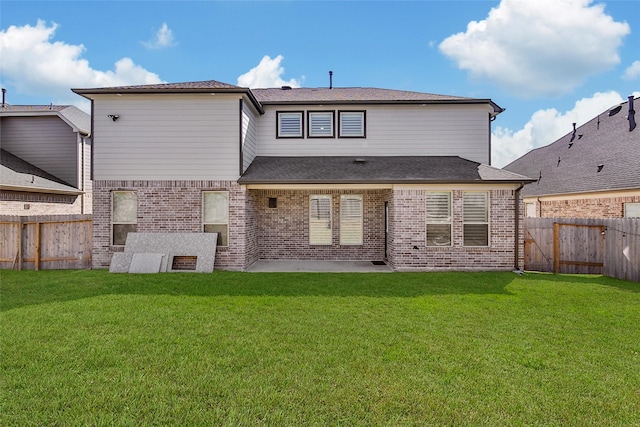 back of house featuring a patio area, brick siding, a lawn, and a fenced backyard