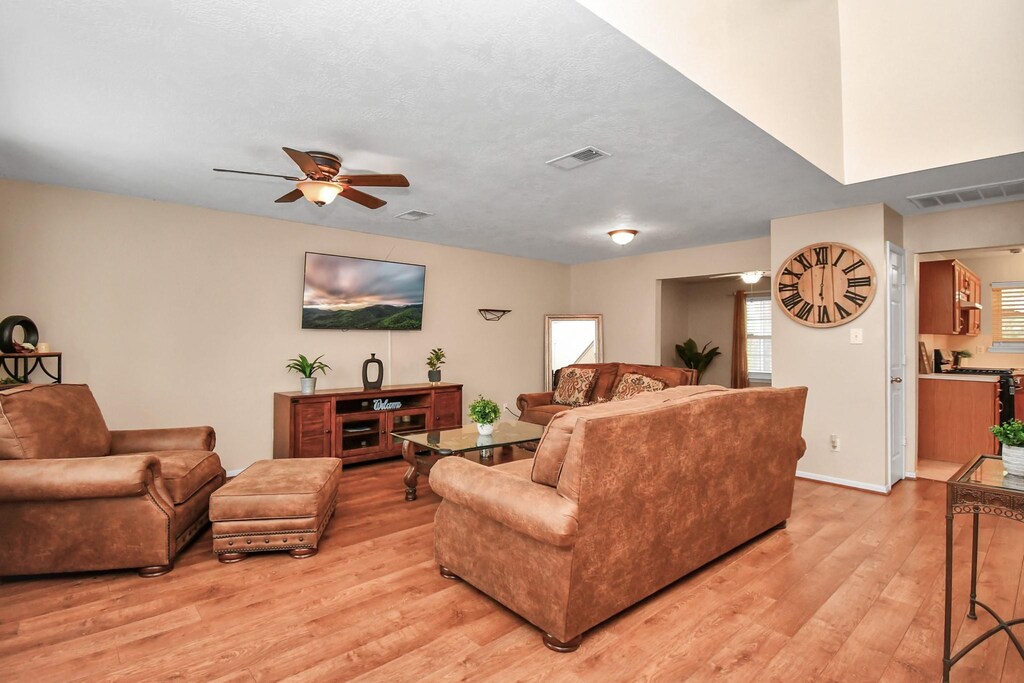 17062 Gaelicglen Ln, Houston, TX 77084 - living area featuring ceiling fan, a textured ceiling, light wood-type flooring, and visible vents