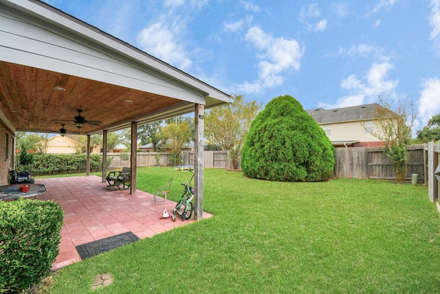 view of yard with a patio area, a fenced backyard, and a ceiling fan