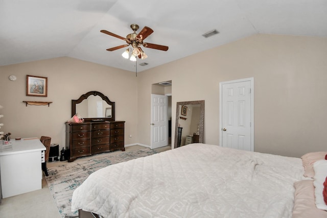 bedroom featuring lofted ceiling, ceiling fan, visible vents, and light colored carpet