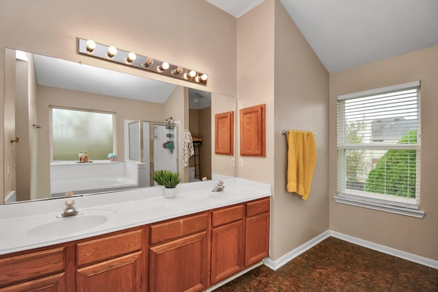 bathroom with vaulted ceiling, a sink, a shower stall, and a bath