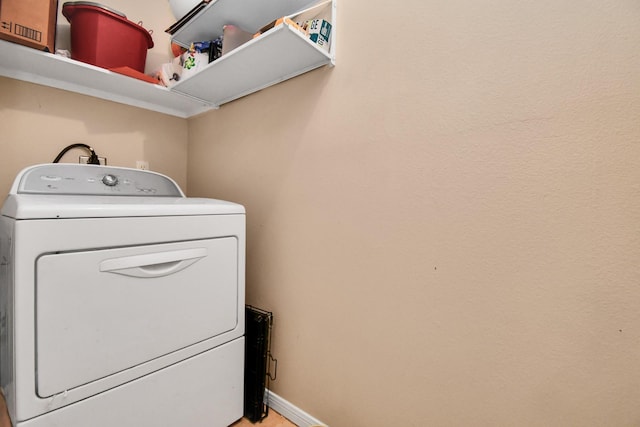 laundry room with washer / dryer, laundry area, and baseboards