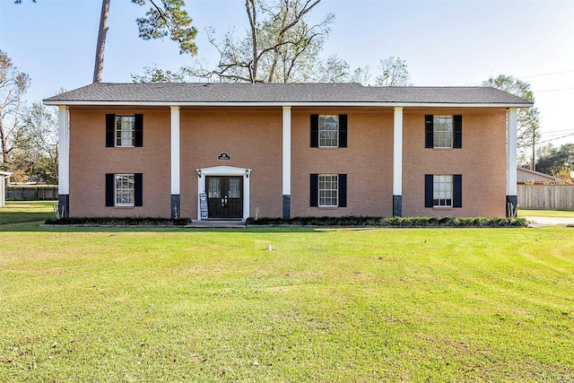 greek revival inspired property featuring a front yard and french doors