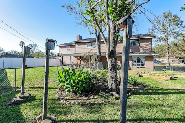 view of yard with fence and a vegetable garden