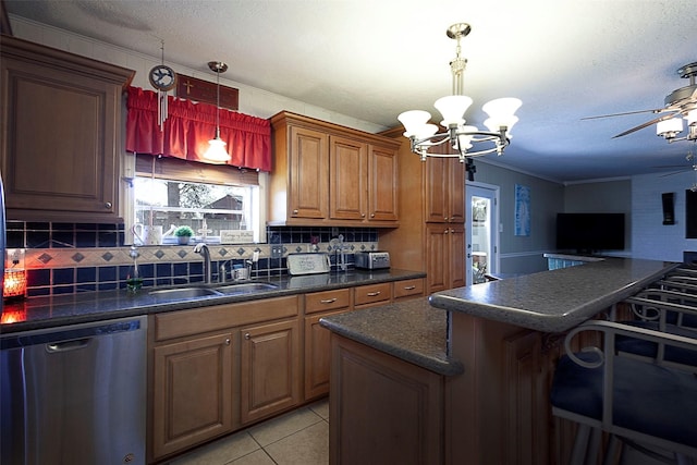 kitchen with a sink, a kitchen breakfast bar, ornamental molding, stainless steel dishwasher, and dark countertops