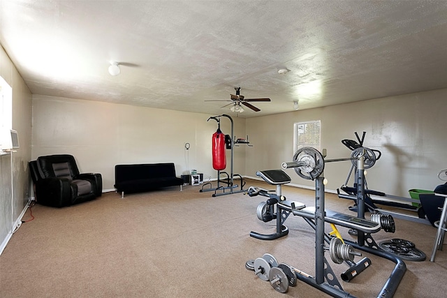 exercise area featuring a textured ceiling, ceiling fan, and carpet flooring