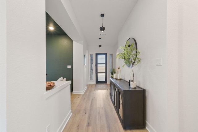 interior space with light wood-style floors, visible vents, and baseboards