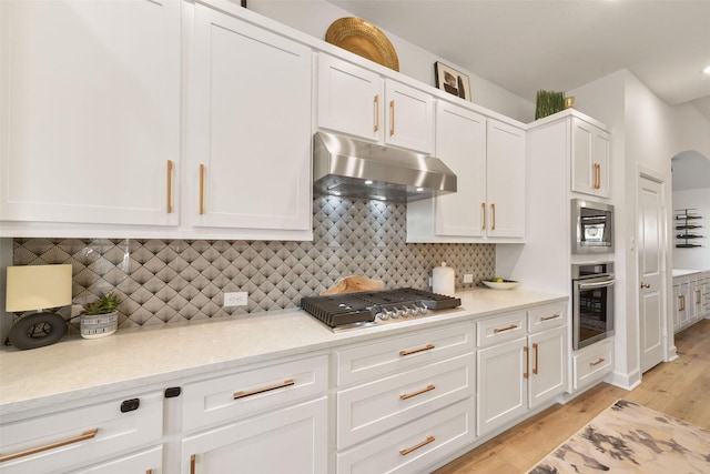 kitchen featuring appliances with stainless steel finishes, white cabinets, and under cabinet range hood