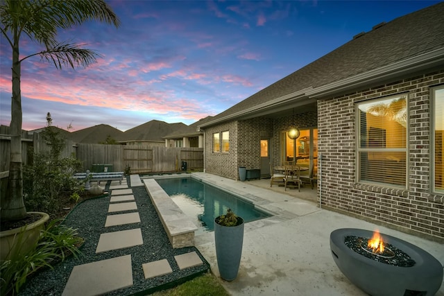 view of pool featuring a fenced backyard, a fenced in pool, and a patio