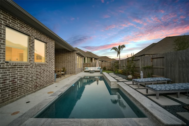 view of pool with a fenced backyard, outdoor lounge area, a fenced in pool, and a patio