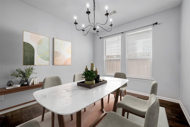 dining space with baseboards, visible vents, and wood finished floors