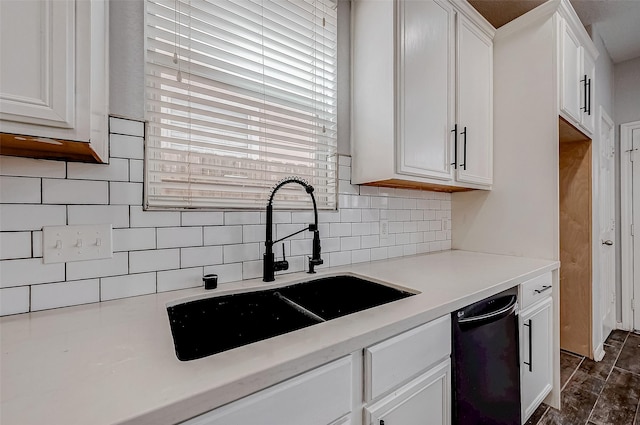 kitchen with tasteful backsplash, light countertops, white cabinets, a sink, and dishwasher