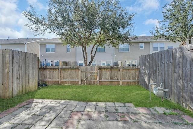 view of yard with a patio and a fenced backyard