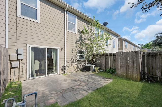 back of property featuring a patio area, fence, and a lawn