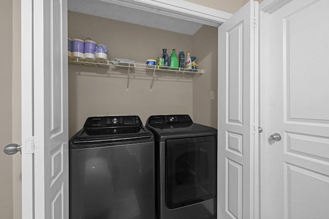 washroom featuring laundry area and washing machine and clothes dryer