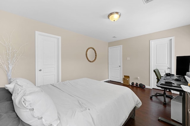 bedroom featuring dark wood-type flooring and baseboards