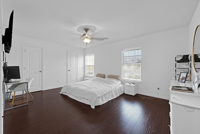 bedroom featuring ceiling fan, baseboards, and dark wood finished floors