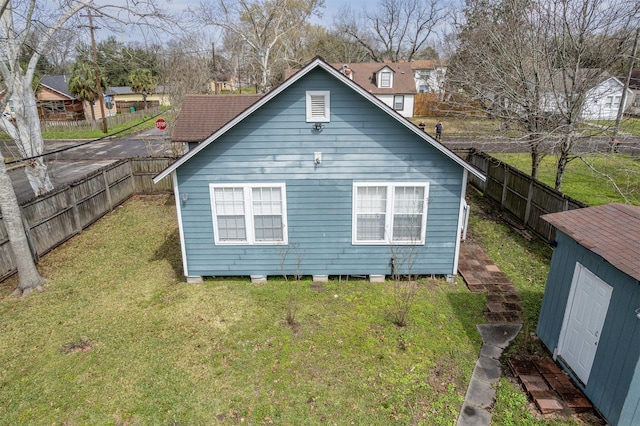 exterior space with a yard, an outdoor structure, and a fenced backyard