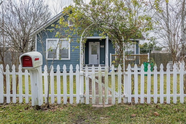 view of front of house with a fenced front yard and a porch