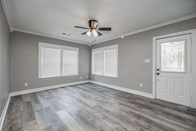 entrance foyer with a ceiling fan, baseboards, visible vents, dark wood finished floors, and crown molding