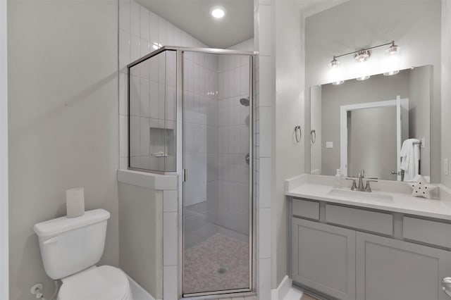 full bath with toilet, a shower stall, and vanity