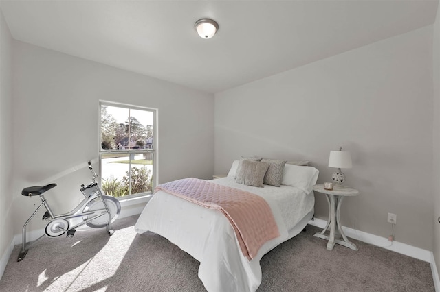 carpeted bedroom featuring baseboards