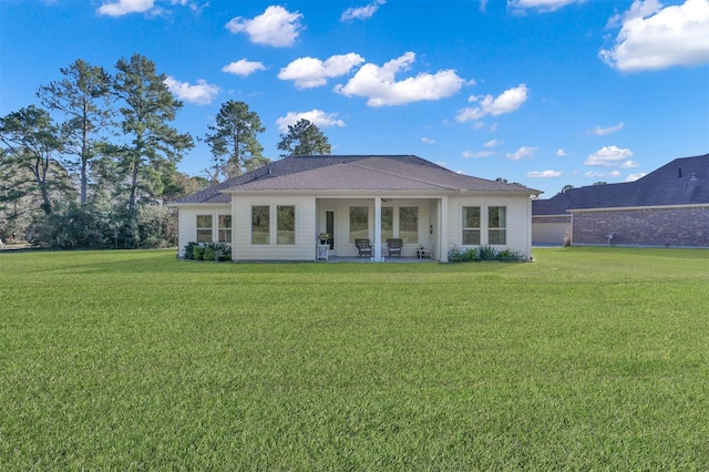 rear view of house with a yard and a patio area