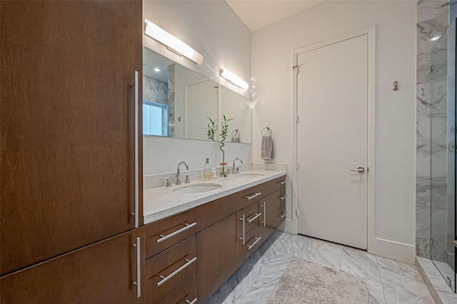 bathroom with marble finish floor, double vanity, a shower, and a sink