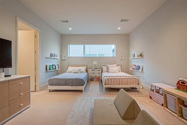 bedroom featuring visible vents, light carpet, and baseboards