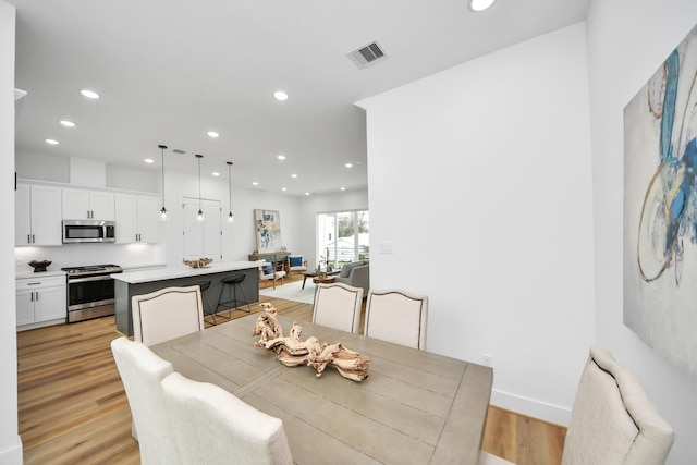 dining room featuring recessed lighting, visible vents, and light wood-style floors