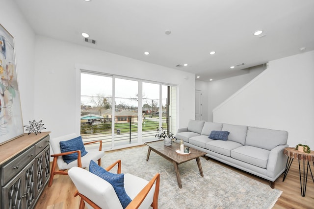 living area featuring light wood finished floors, visible vents, and recessed lighting