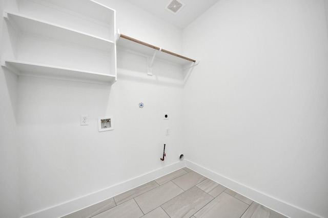 clothes washing area featuring hookup for an electric dryer, hookup for a gas dryer, laundry area, washer hookup, and visible vents