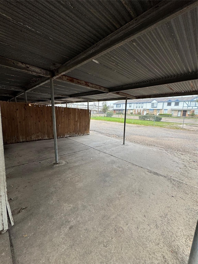 garage with covered parking and fence