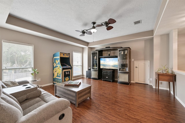 2433 La Rochelle Ct, Seabrook, TX 77586 - living area featuring visible vents, a textured ceiling, plenty of natural light, and dark wood-style floors