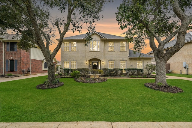 2433 La Rochelle Ct, Seabrook, TX 77586 - view of front of house with curved driveway, a front lawn, and brick siding