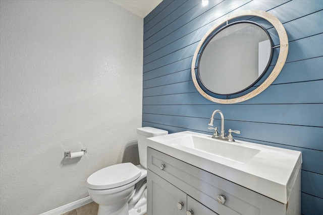 half bathroom featuring toilet and vanity