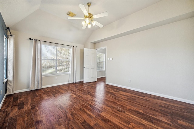 unfurnished bedroom with lofted ceiling, wood finished floors, visible vents, a ceiling fan, and baseboards