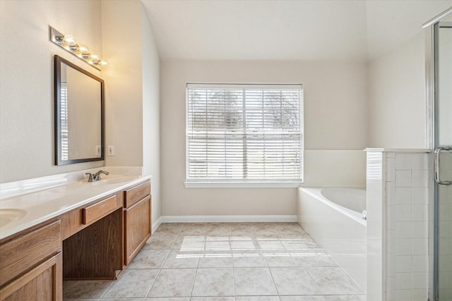 full bathroom with double vanity, a sink, a shower stall, a bath, and tile patterned floors