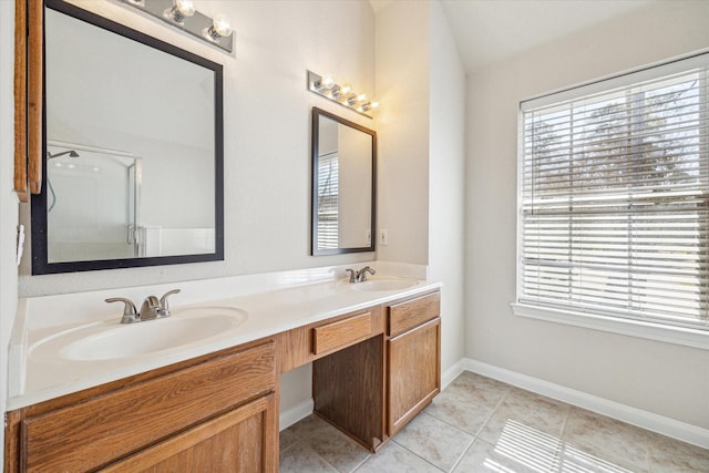 bathroom featuring double vanity, tile patterned flooring, a sink, and a shower with shower door