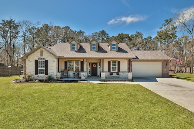 view of front facade with a front lawn, fence, a porch, concrete driveway, and an attached garage