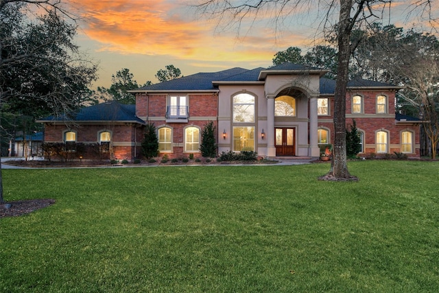 view of front of property with brick siding and a front lawn