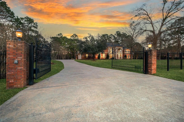 view of gate featuring a yard and fence