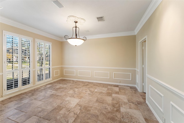 unfurnished room with stone finish flooring, ornamental molding, visible vents, and a decorative wall